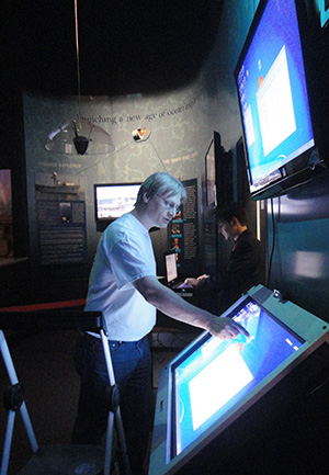 man using touch screen at science center